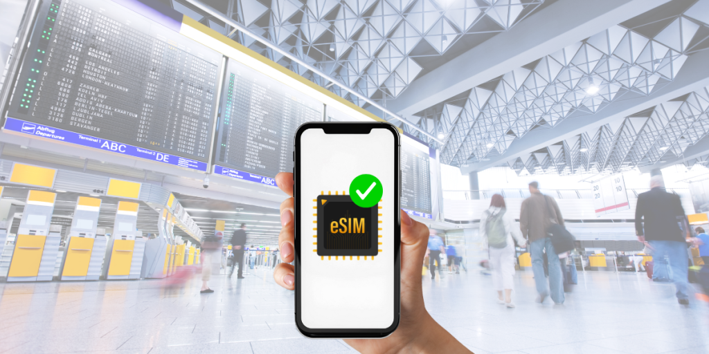 Traveler holding phone with eSIM ready to activate at airport arrival terminal